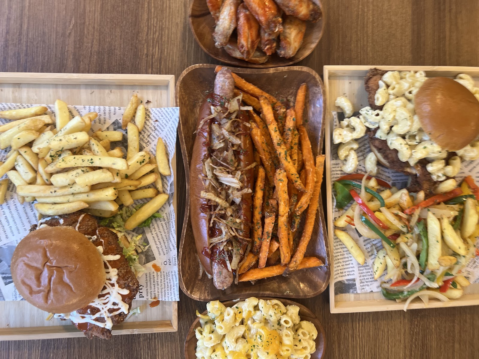 Spread of pub mains — chicken burger, hot dog with sweet potato fries, mac & cheese and chicken wings (photo: The Malt Man)